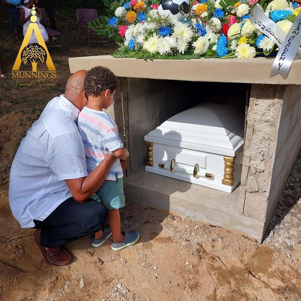 baby ian at his brothers laddie gillett grave during funeral