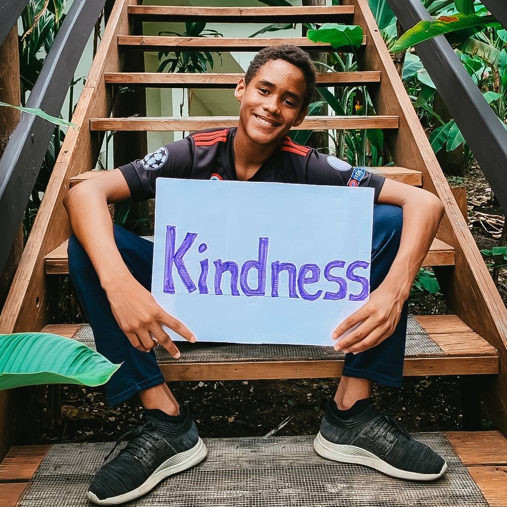 laddie portrait holding kindness sign